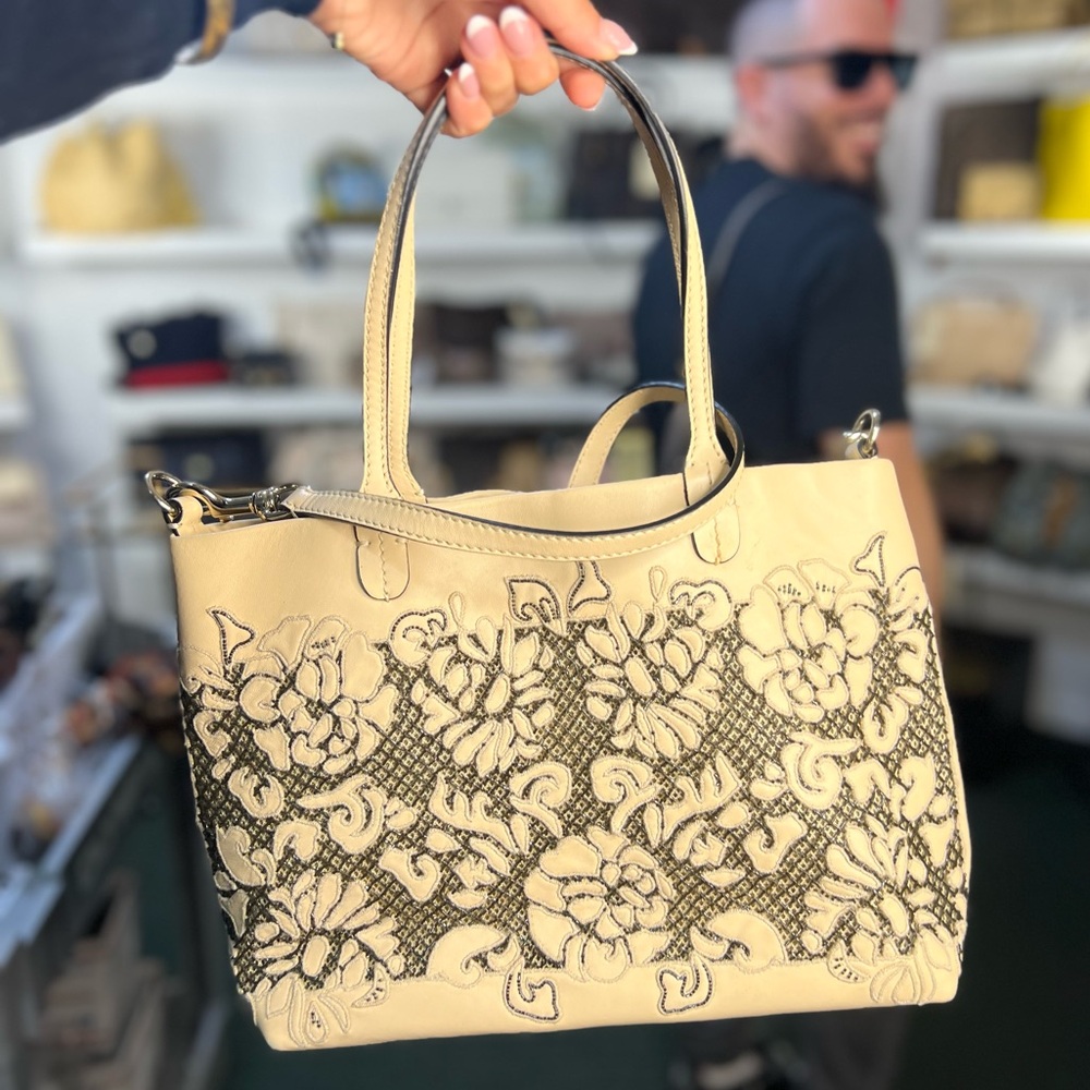 Valentino Garavani Cream Lace-Appliqué tote.
